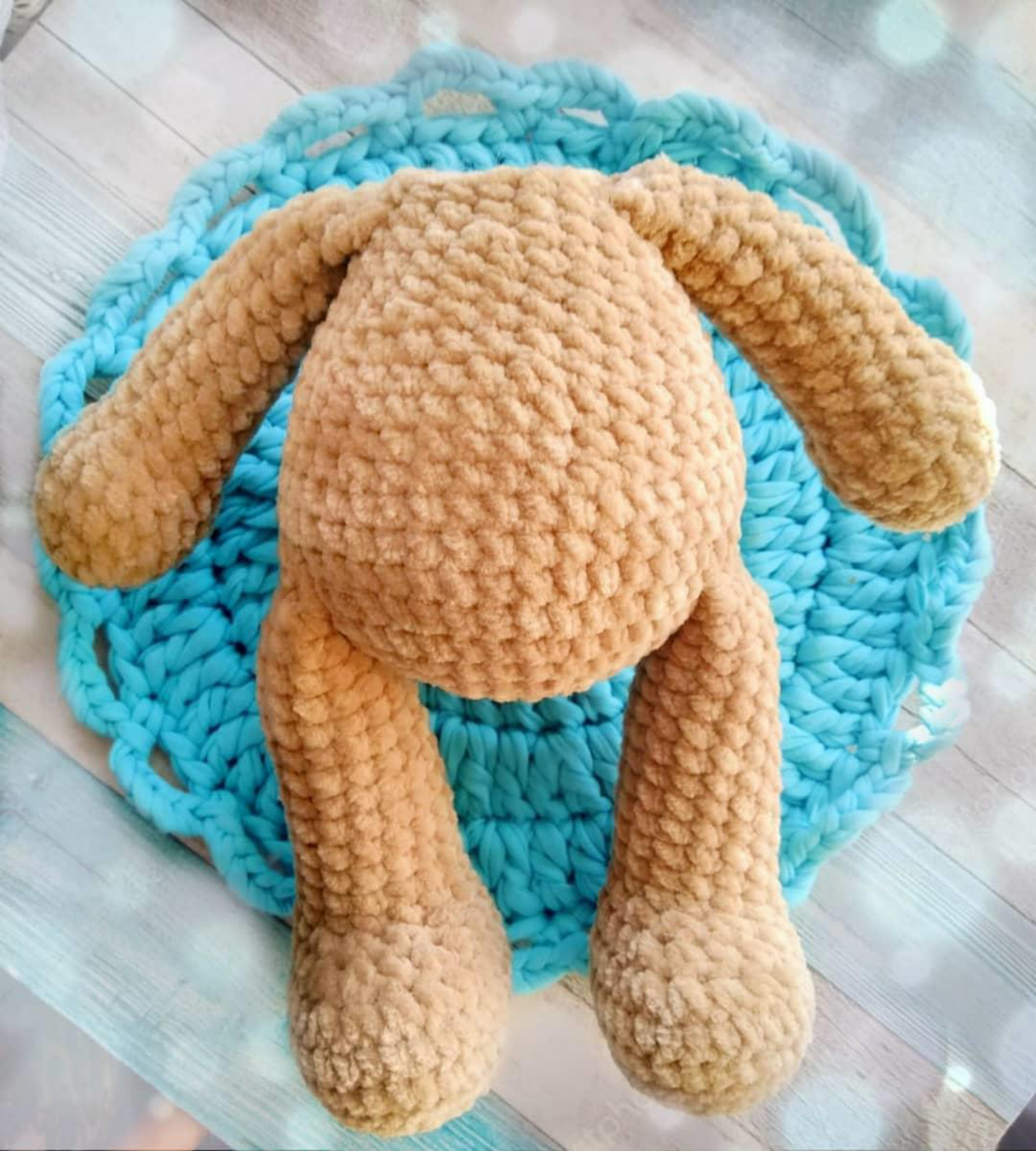 Attaching the crochet arms to the teddy bear's body