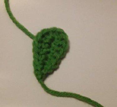 Sewing the crochet stem around a wooden dowel