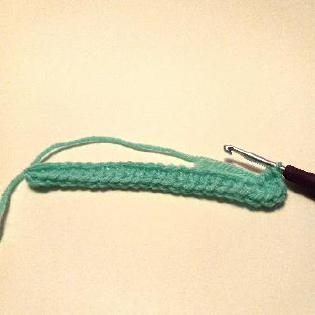 Step 2: Crocheting 5 HDC stitches into the last chain to create a curve.