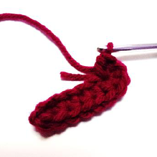 Close up of crochet work showing a short yarn tail
