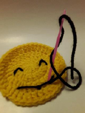 The back of the coaster with secured knots.