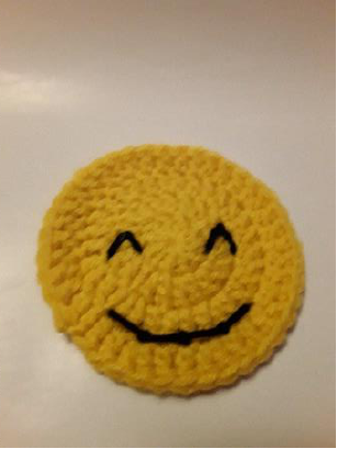 The face with embroidered eyes and mouth, before the tongue is attached.