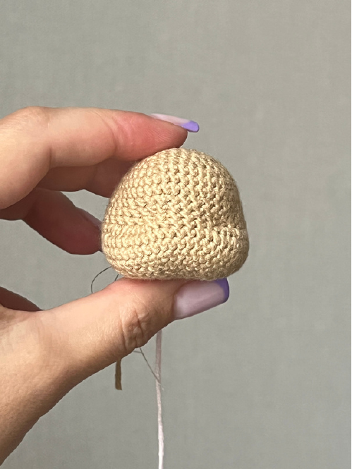 Crochet head with embroidered sleeping eyes