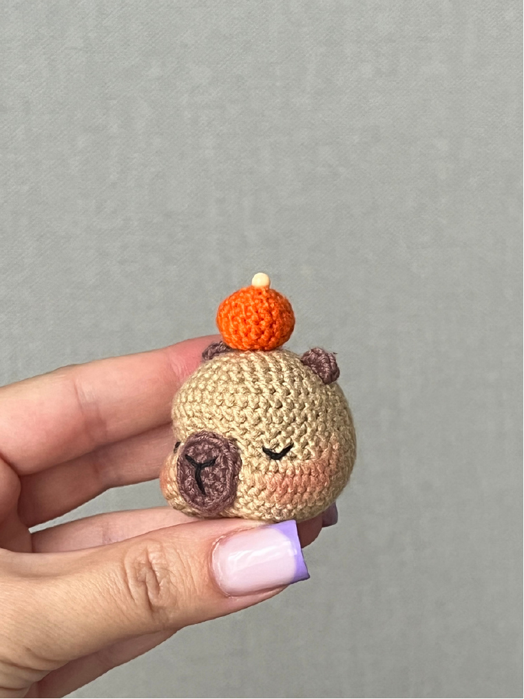 Crochet orange with green leaf attached