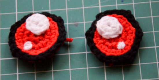 Crocheted eyes with white reflections sewn on