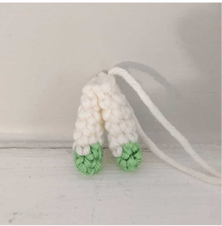 Close-up of the crocheted head of the toy, showing eye placement