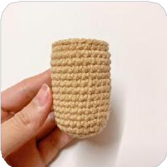 Two small, dark brown crocheted ear-like pieces for the capybara.