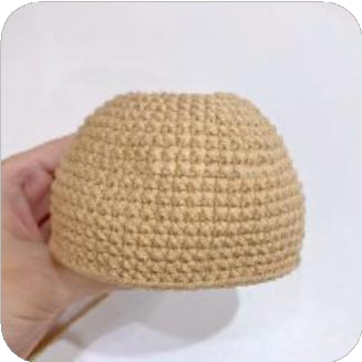 Two small, dark brown crocheted leg-like pieces for the capybara's back legs.