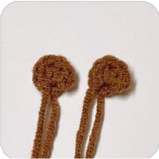 The capybara's head with two simple embroidered closed eyes.