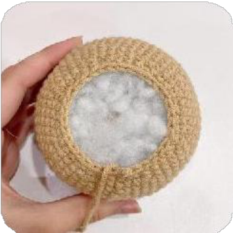 The capybara's head with the two ears securely sewn in place.