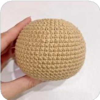 The completed capybara head featuring embroidered eyes, attached ears, and the detailed nose.