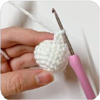 The crocheted cup shape being gently flattened and folded to form petal structure.