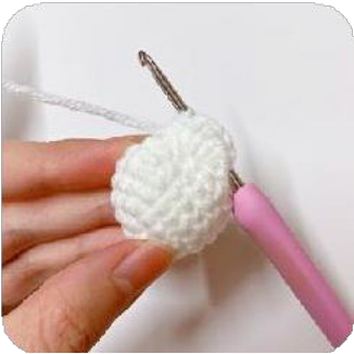 A close-up of the folded crocheted piece, resembling a delicate flower petal.