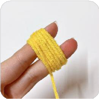 The wrapped yellow yarn secured in the middle with a wire and cut to form individual threads for the pistil.