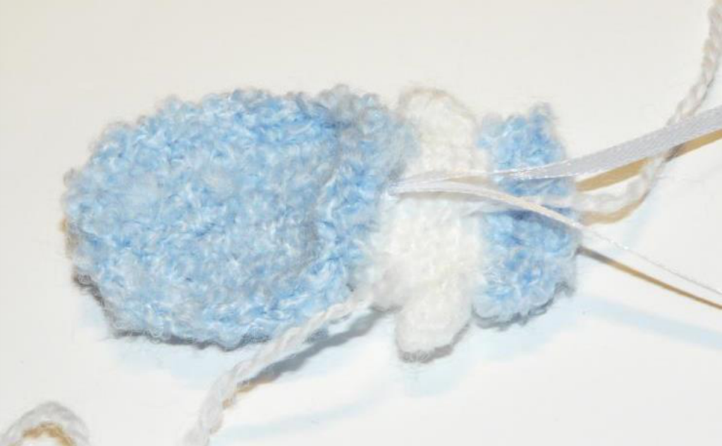 Crochet sheep ear in progress, showing the flat piece