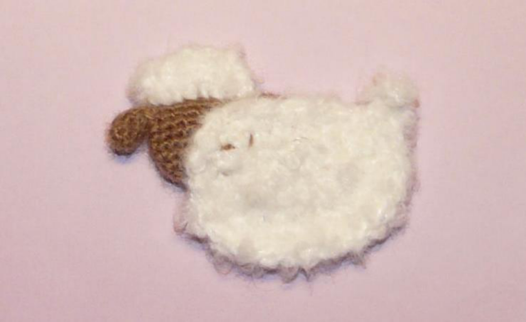 Two finished crochet sheep ears, folded and ready for attachment