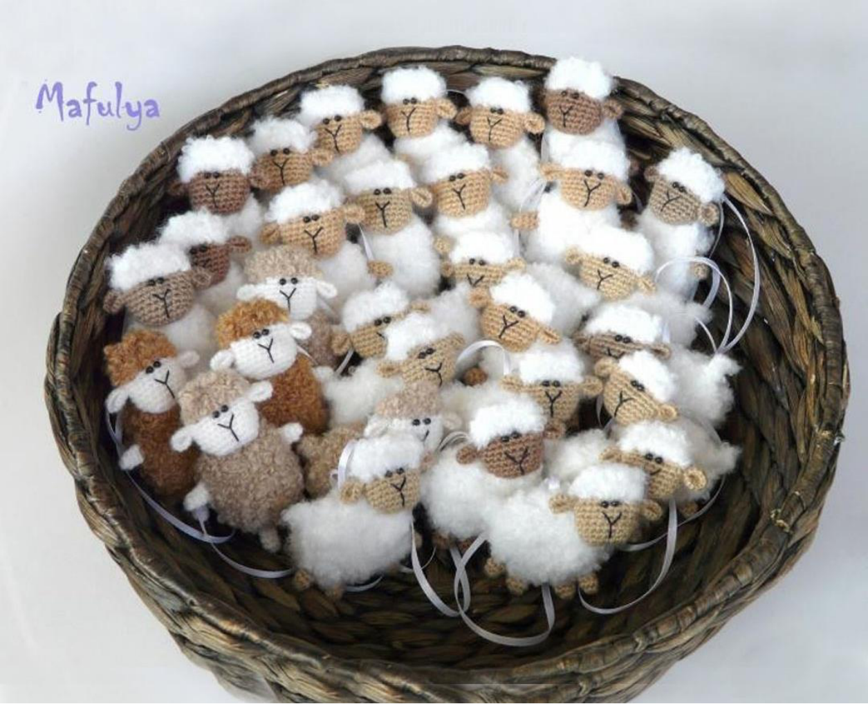 Collection of finished crochet sheep in various colors and poses